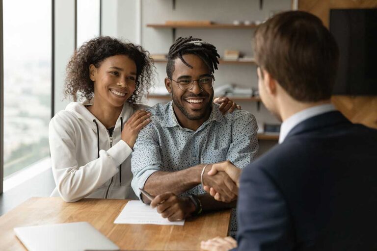 A person reviews health insurance paperwork while speaking with a mental health counselor.